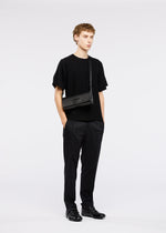 A model wears the GOOD GOODS ISSEY MIYAKE BOX bag.
