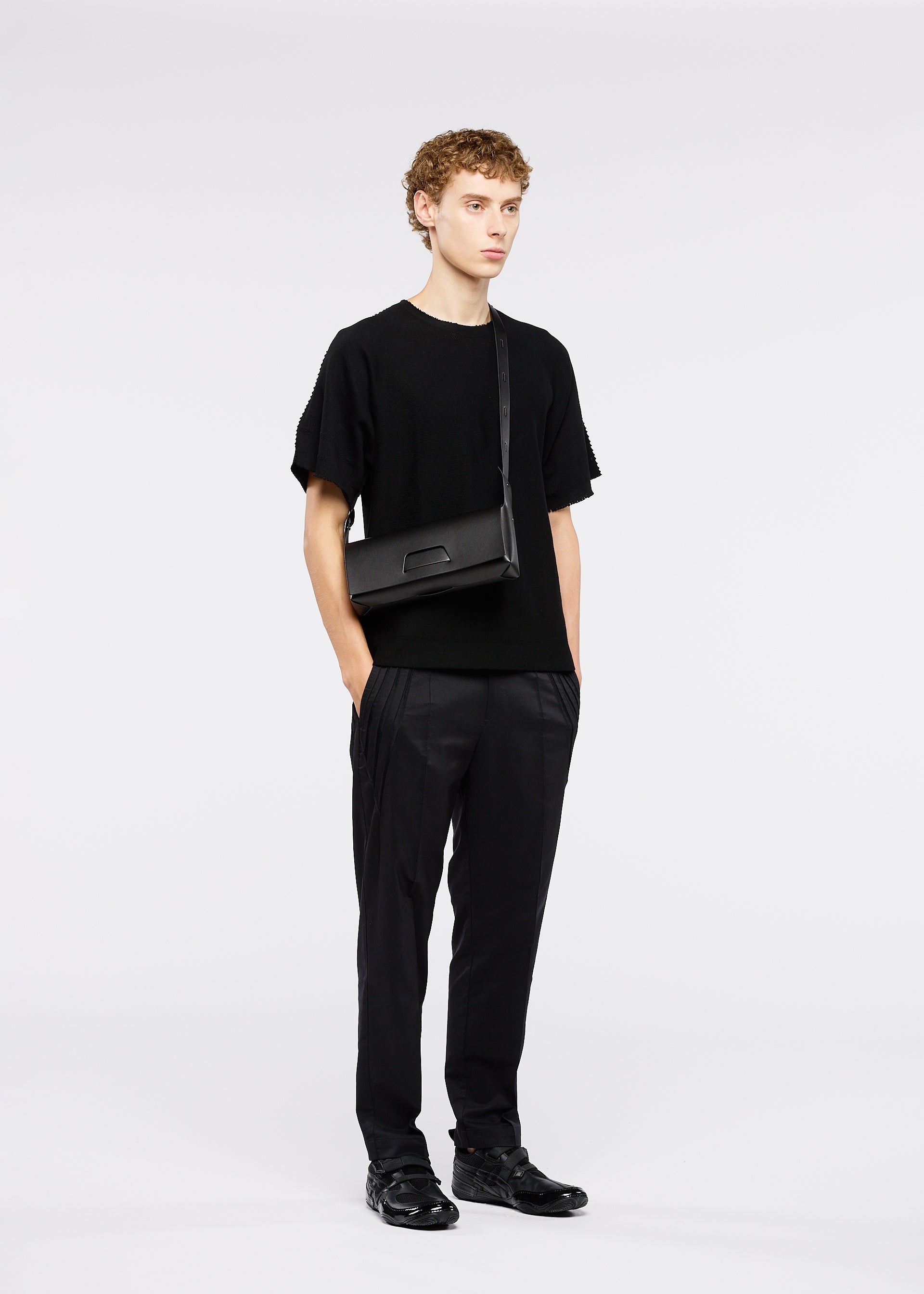 A model wears the GOOD GOODS ISSEY MIYAKE BOX bag.