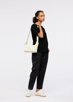 A model wears the GOOD GOODS ISSEY MIYAKE BOX bag.