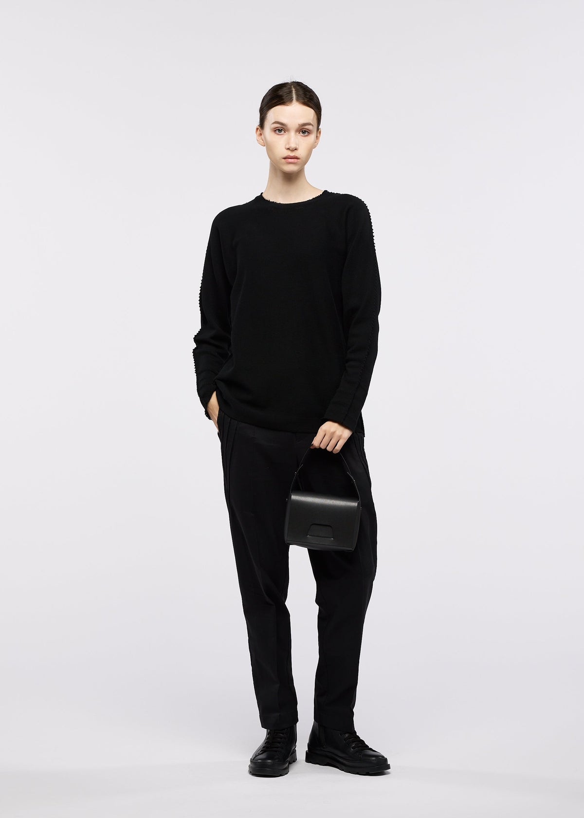 A model wears the GOOD GOODS ISSEY MIYAKE BOX box-handbag-silver.