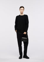 A model wears the GOOD GOODS ISSEY MIYAKE BOX box-handbag-silver.