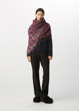 A model wears the HAAT CRAPE TARTAN STOLE stole.