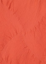 A detail shot of the HAAT  KYO CHIJIMI SQUARE SPIRAL dress