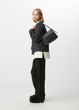 A model wears the HAAT CHENILLE VELOUR bag.