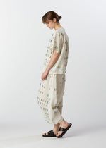 A model wears the HAAT KOMOREBI trousers.