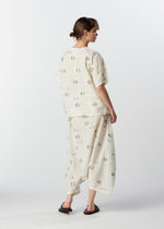 A model wears the HAAT KOMOREBI trousers.