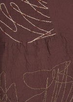 A detail shot of the HAAT KYO CHIJIMI HOTARU skirt.