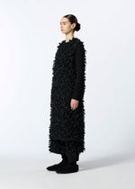 A model wears the HAAT RIBBON TWEED clothing.