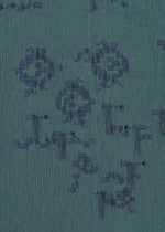 A detail shot of the HAAT KYO CHIJIMI CUT LOOP dress.