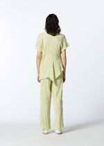 A model wears the HAAT KYO CHIJIMI CUT LOOP shirt.
