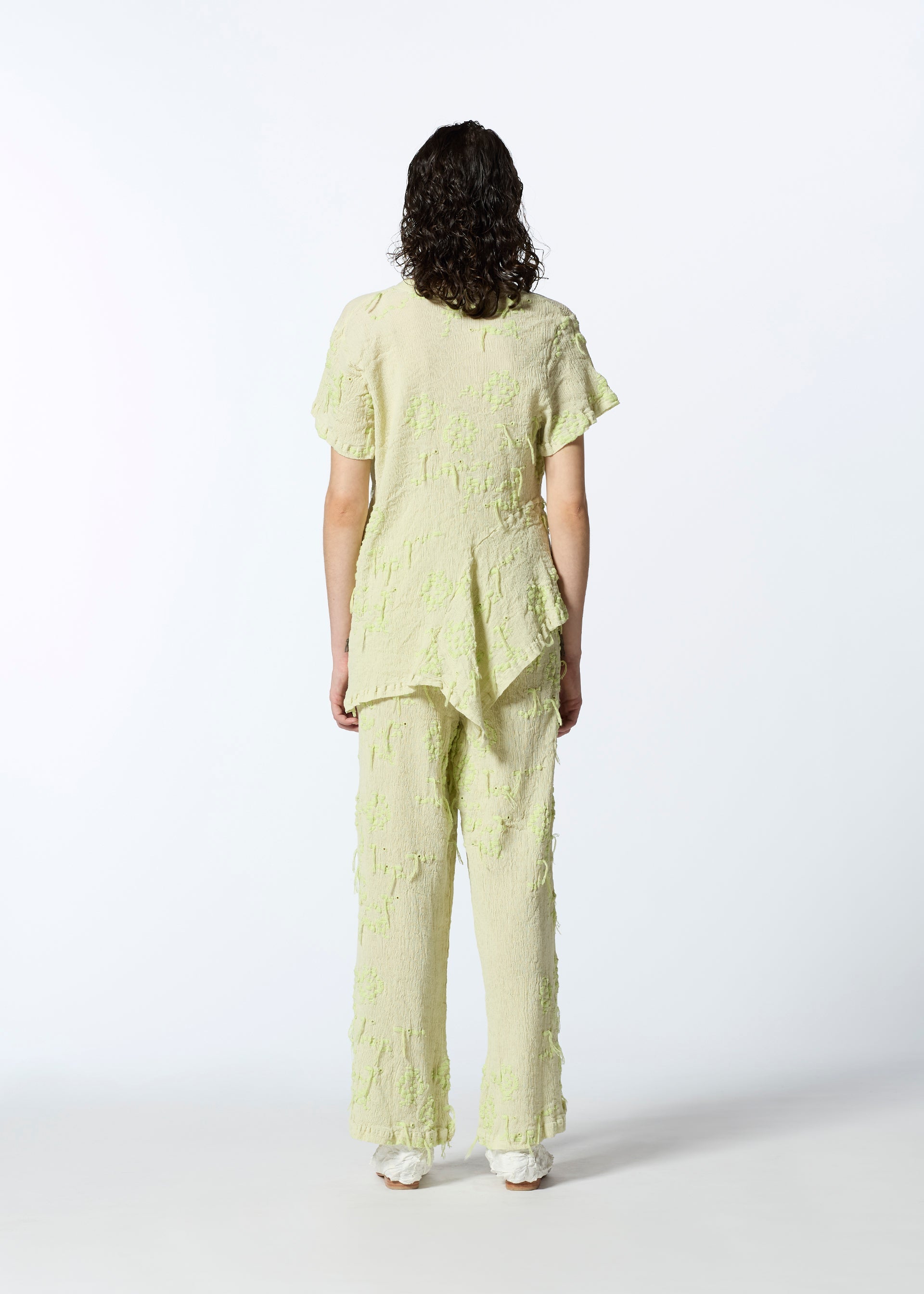 A model wears the HAAT KYO CHIJIMI CUT LOOP shirt.