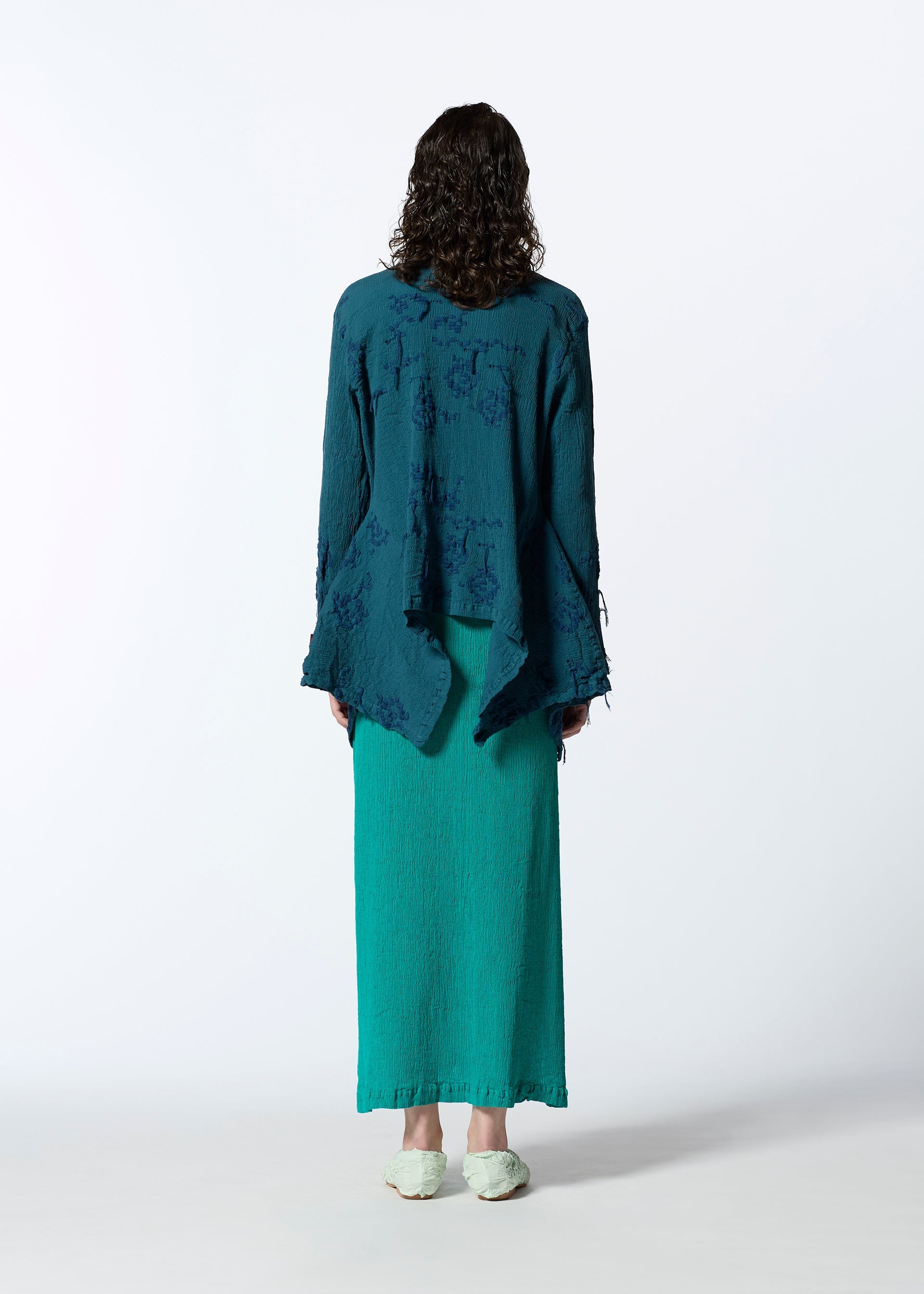 A model wears the HAAT KYO CHIJIMI CUT LOOP shirt.