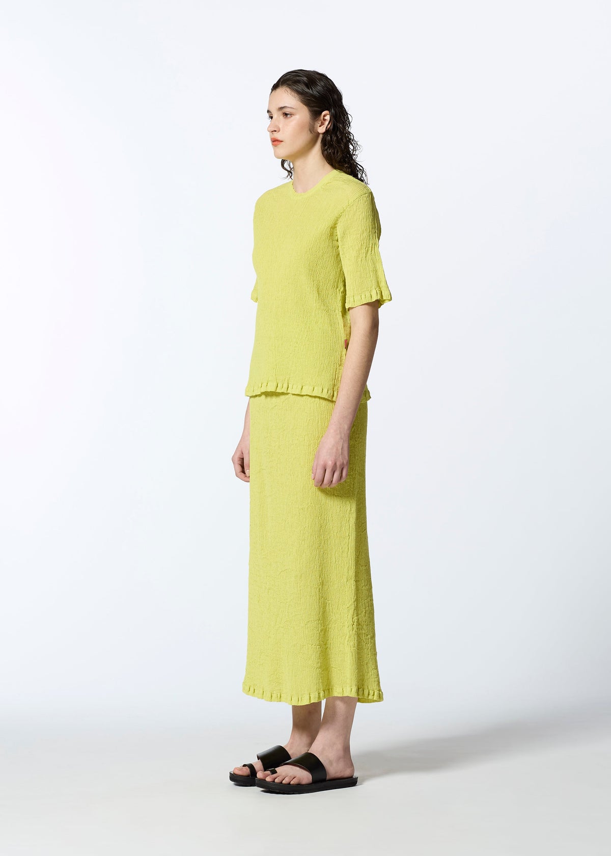 A model wears the HAAT KYO CHIJIMI AUGUST shirt.