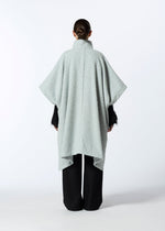 A model wears the HAAT MILLED KNOTS cardigan.