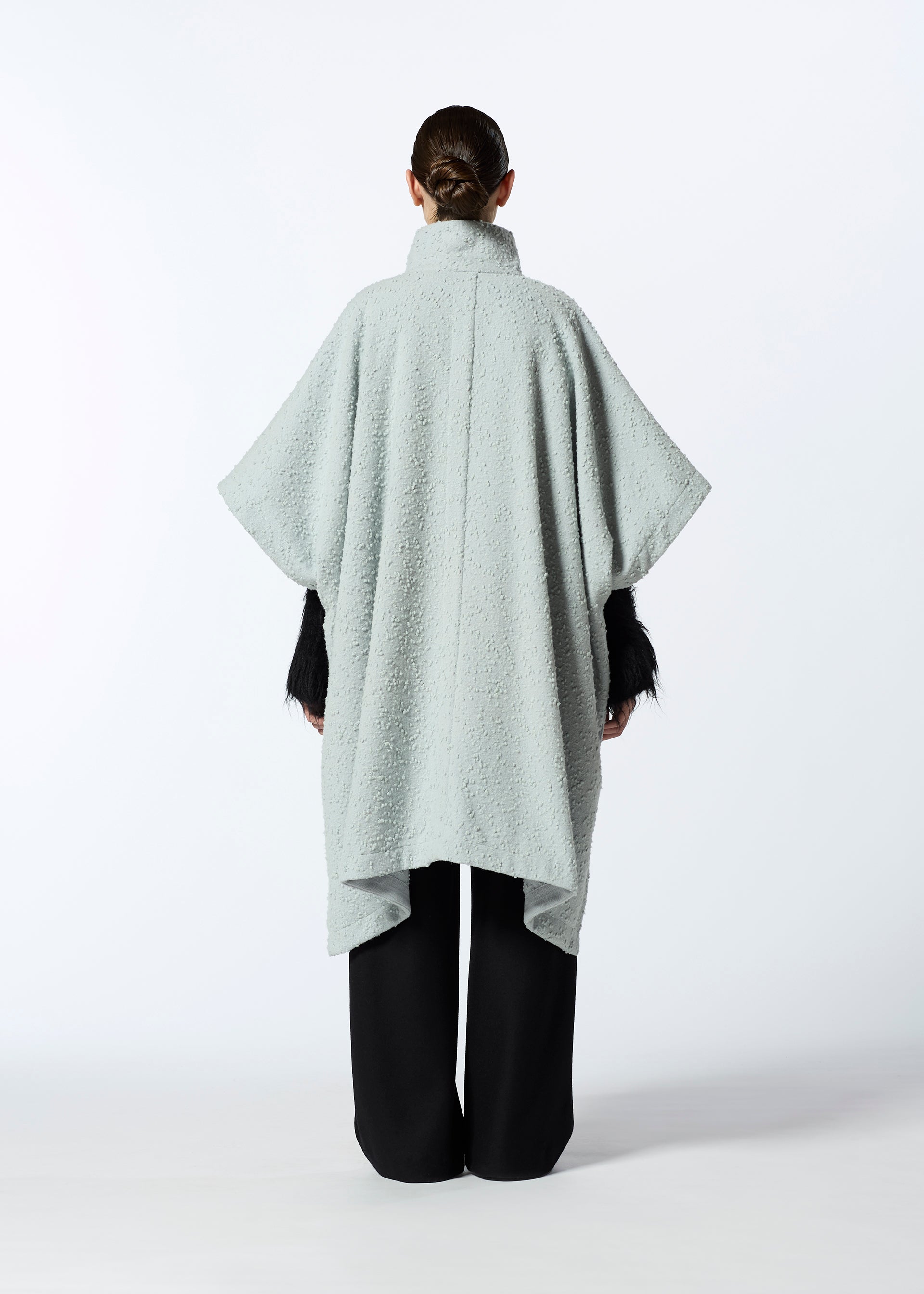 A model wears the HAAT MILLED KNOTS cardigan.