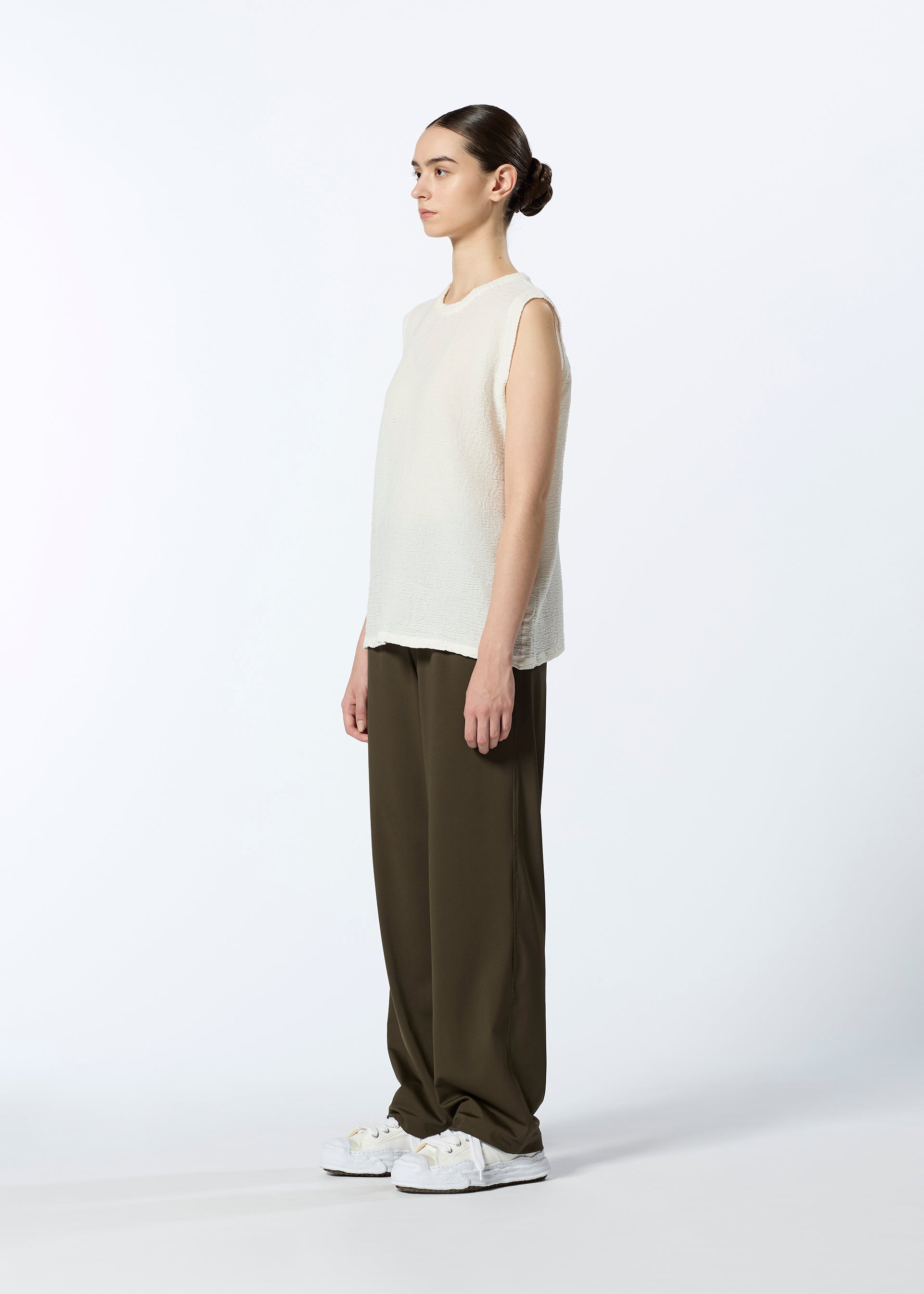 A model wears the HAAT REVERSIBLE BOTTOM trousers.