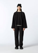 A model wears the HAAT RASCHEL ASSEMBLY trousers.