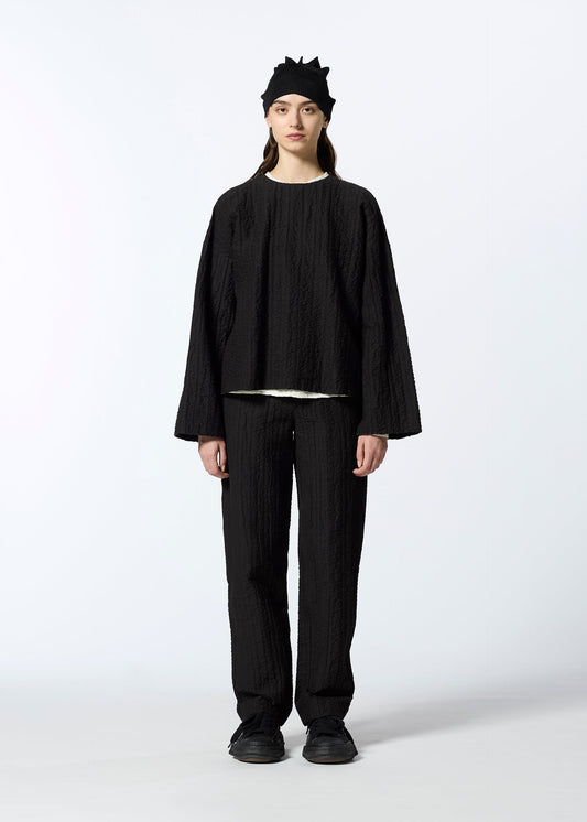 A model wears the HAAT RASCHEL ASSEMBLY trousers.