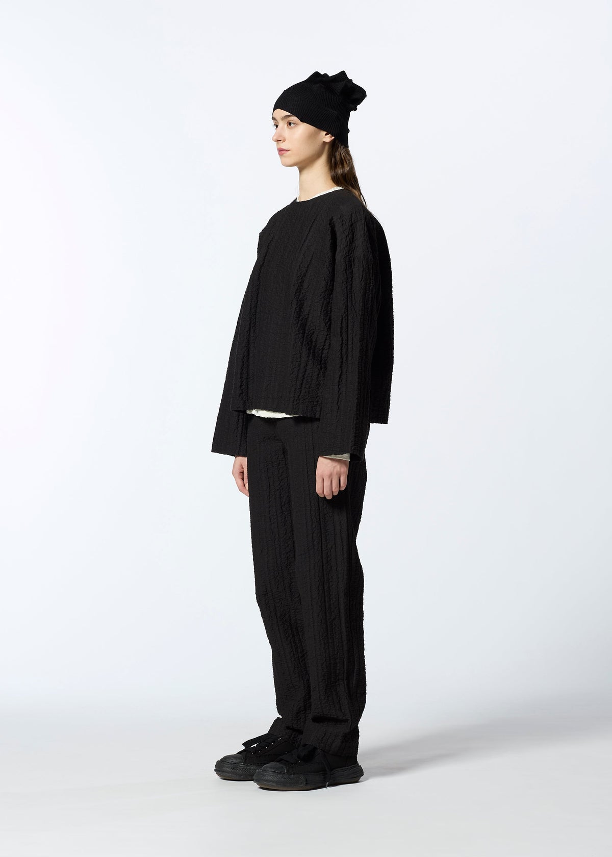 A model wears the HAAT RASCHEL ASSEMBLY trousers.