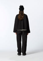 A model wears the HAAT RASCHEL ASSEMBLY trousers.