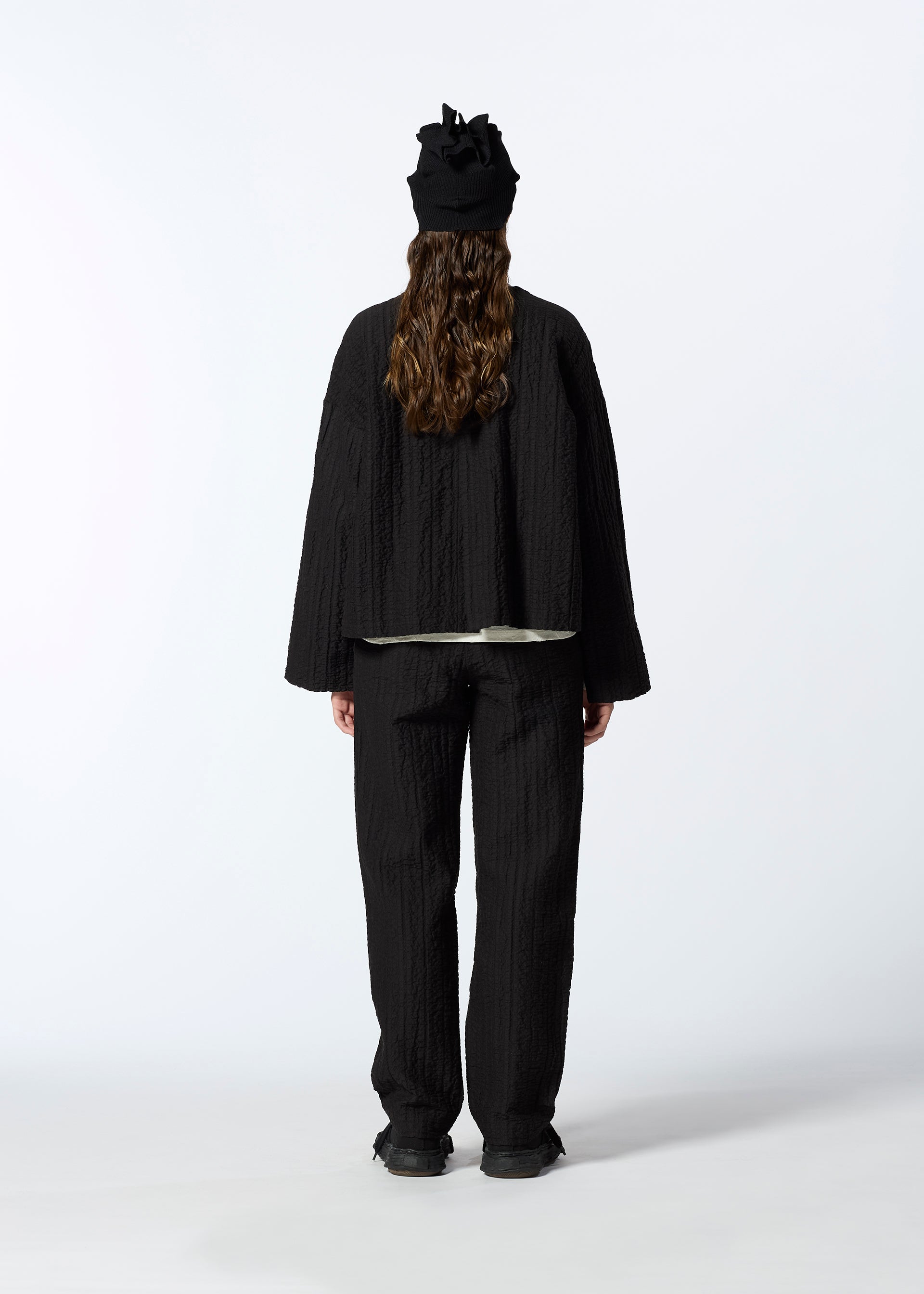 A model wears the HAAT RASCHEL ASSEMBLY trousers.