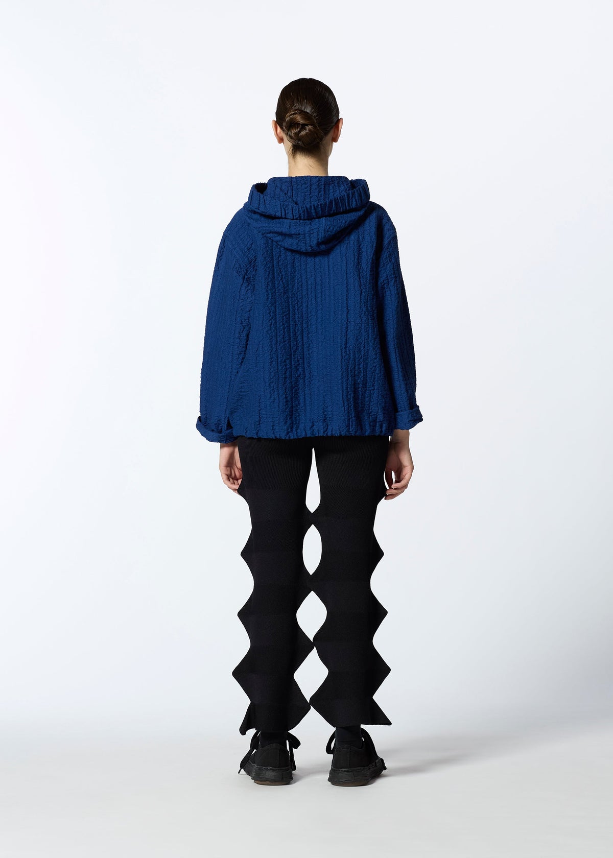 A model wears the HAAT RASCHEL ASSEMBLY cardigan.