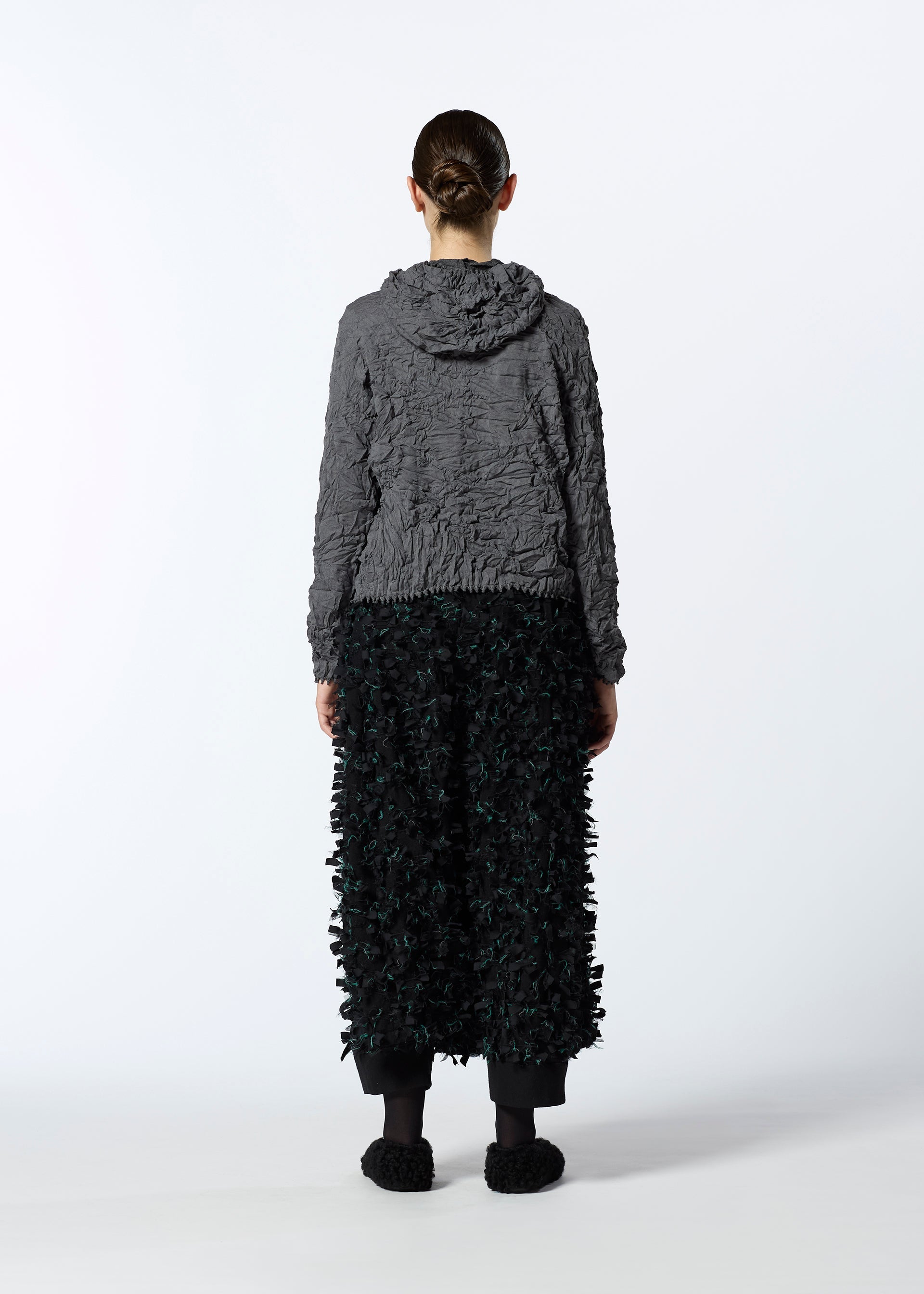 A model wears the HAAT KUMO SHIBORI KNIT clothing.