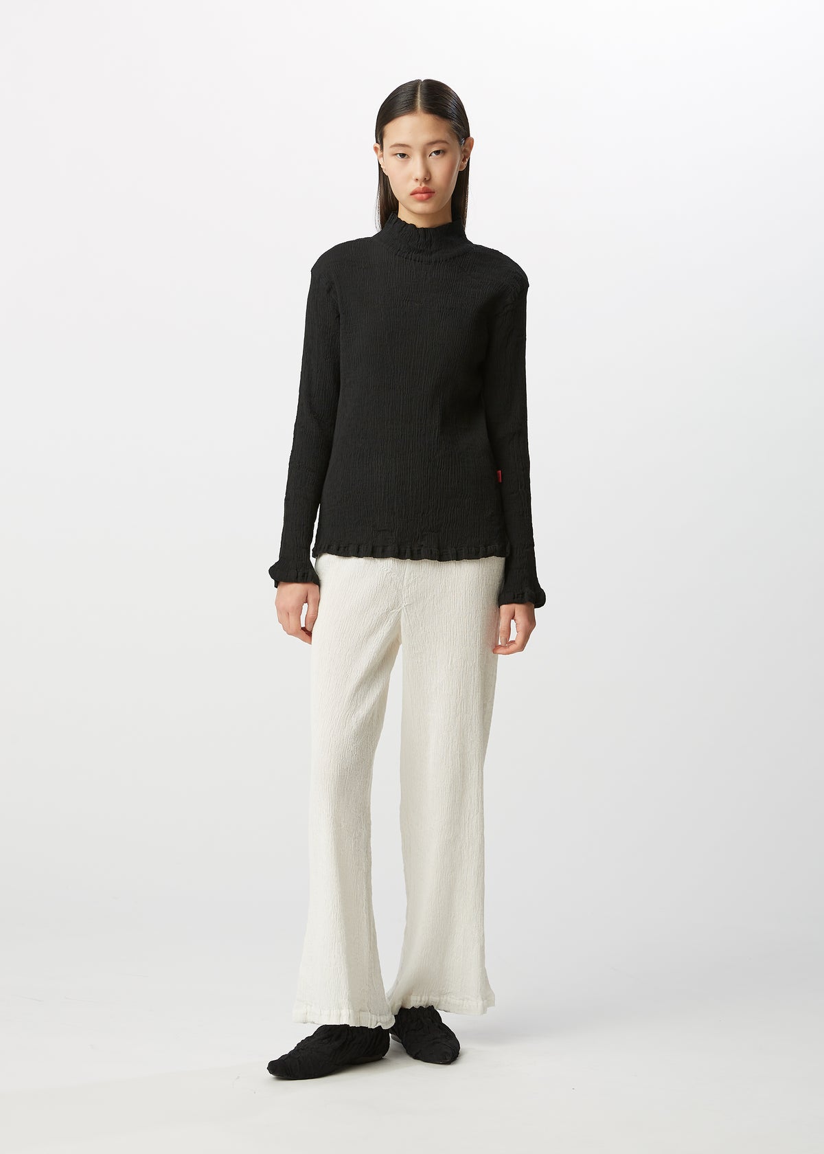 A model wears the HAAT  KYO CHIJIMI BASIC top