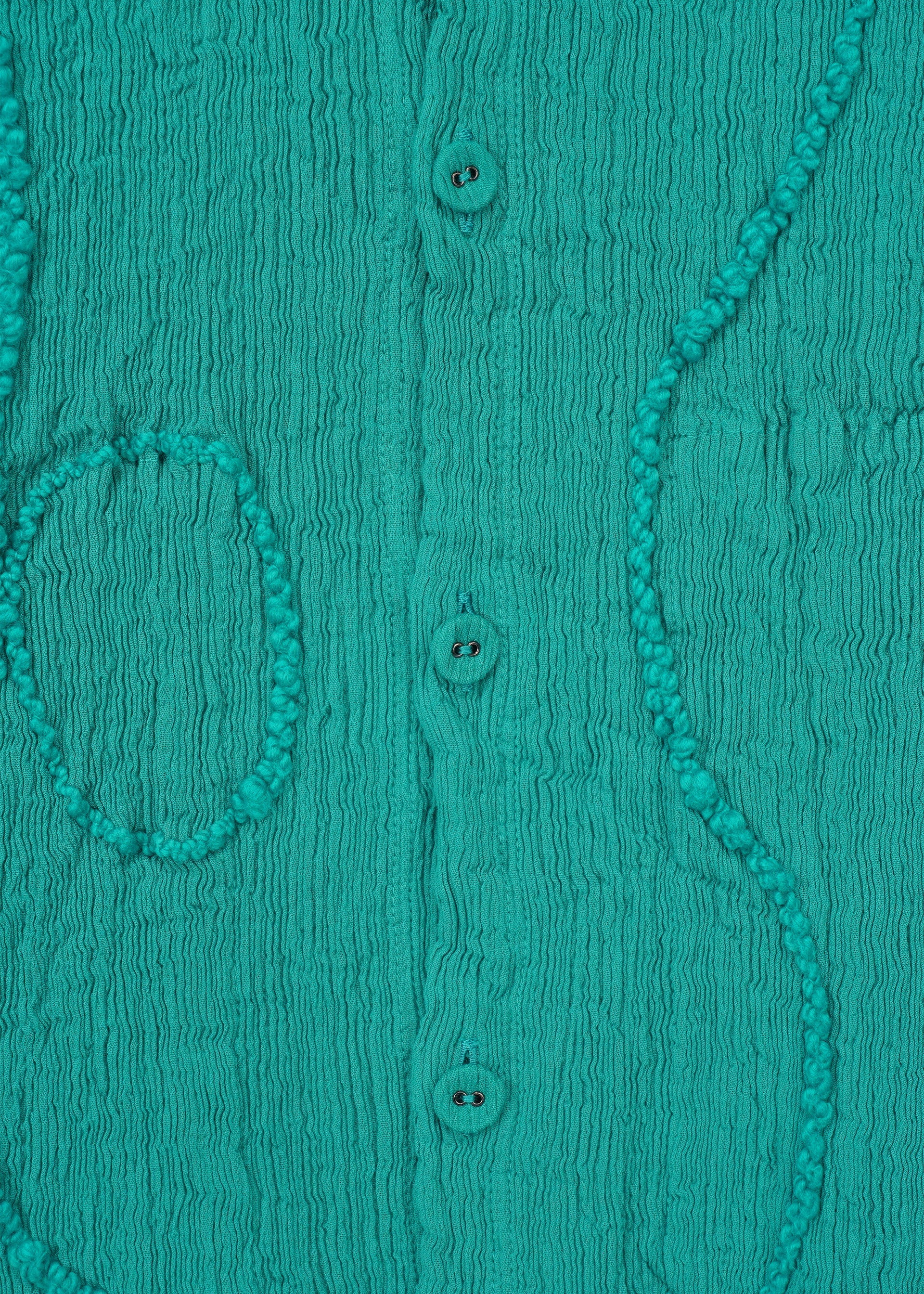 A detail shot of the HAAT KYO CHIJIMI EMB jacket.