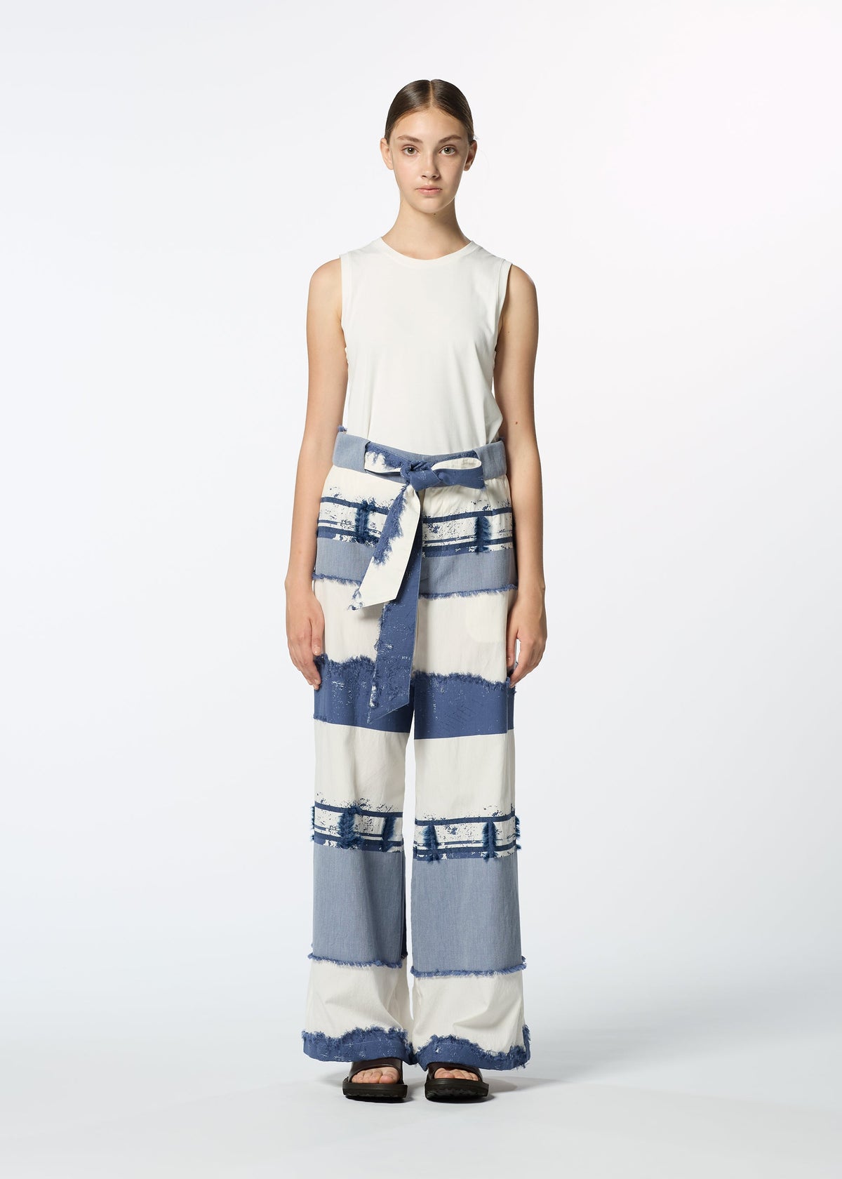 A model wears the HAAT KASANEGAKE trousers.