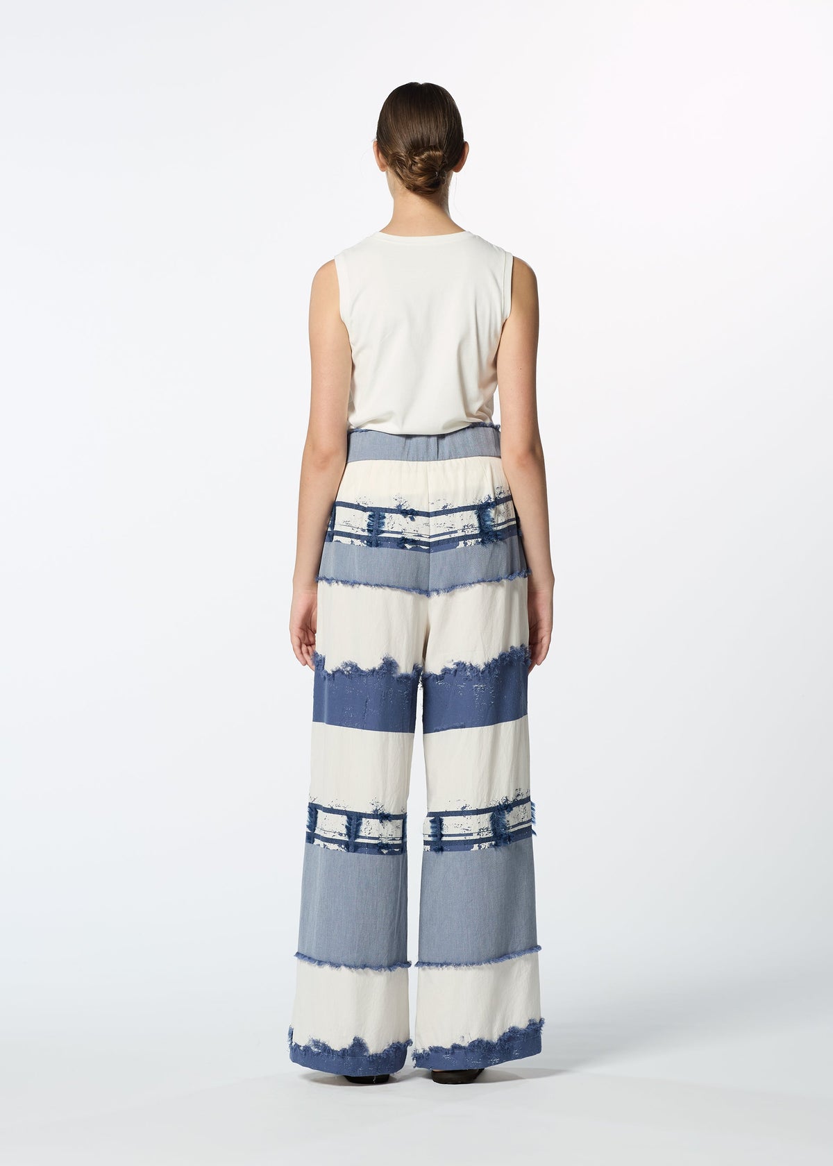 A model wears the HAAT KASANEGAKE trousers.