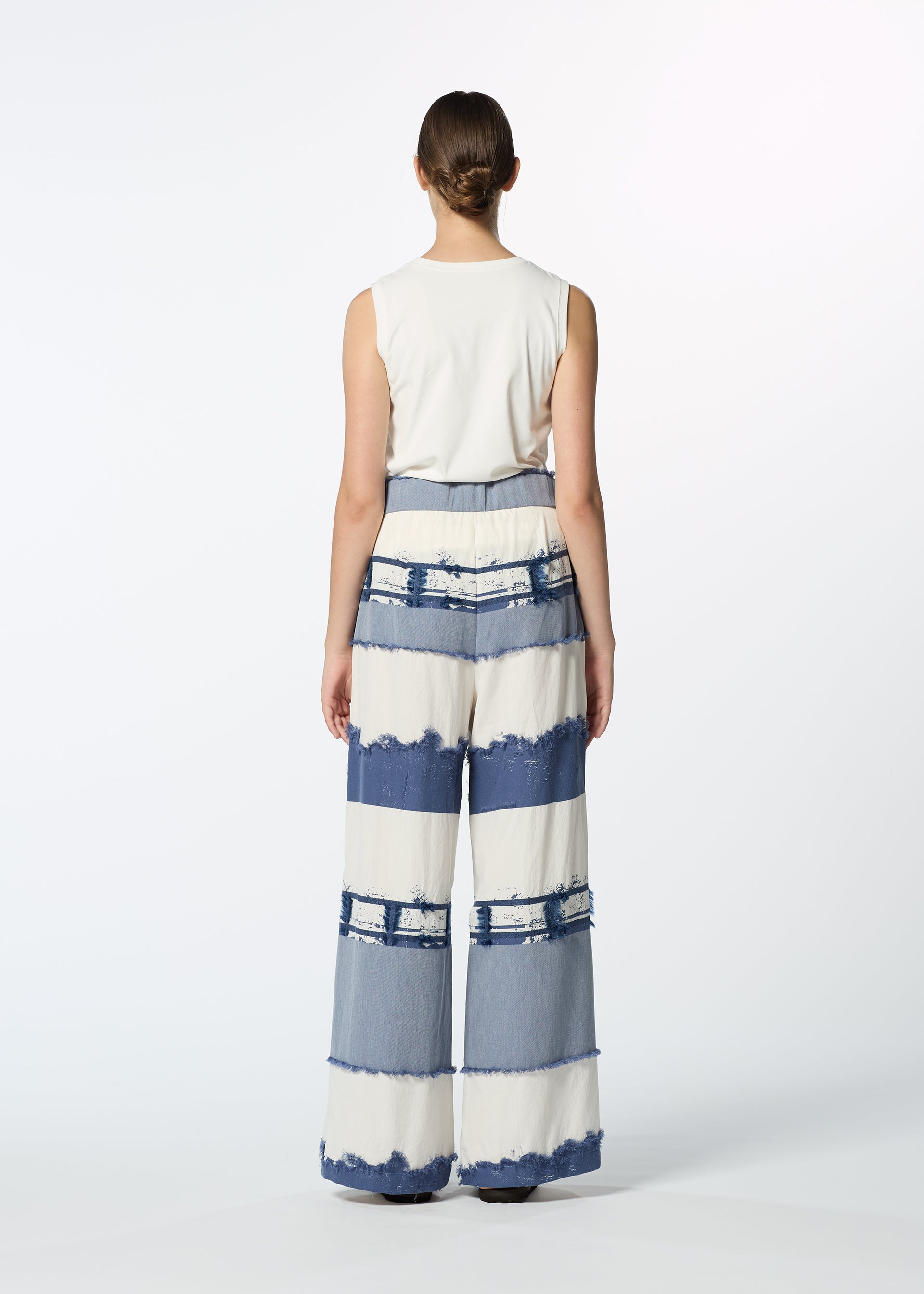 A model wears the HAAT KASANEGAKE trousers.