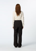 A model wears the HAAT TENMOKU BOTTOM trousers.