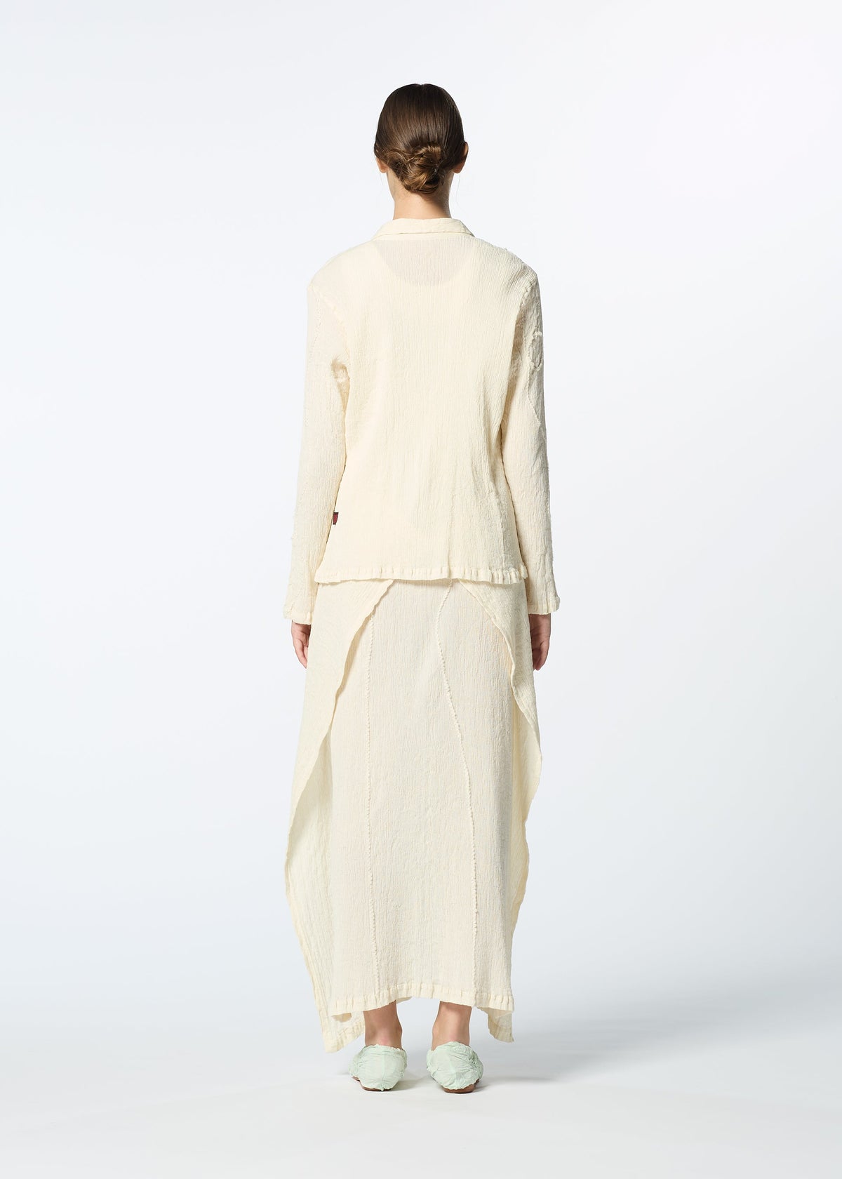 A model wears the HAAT KYO CHIJIMI EMB dress.
