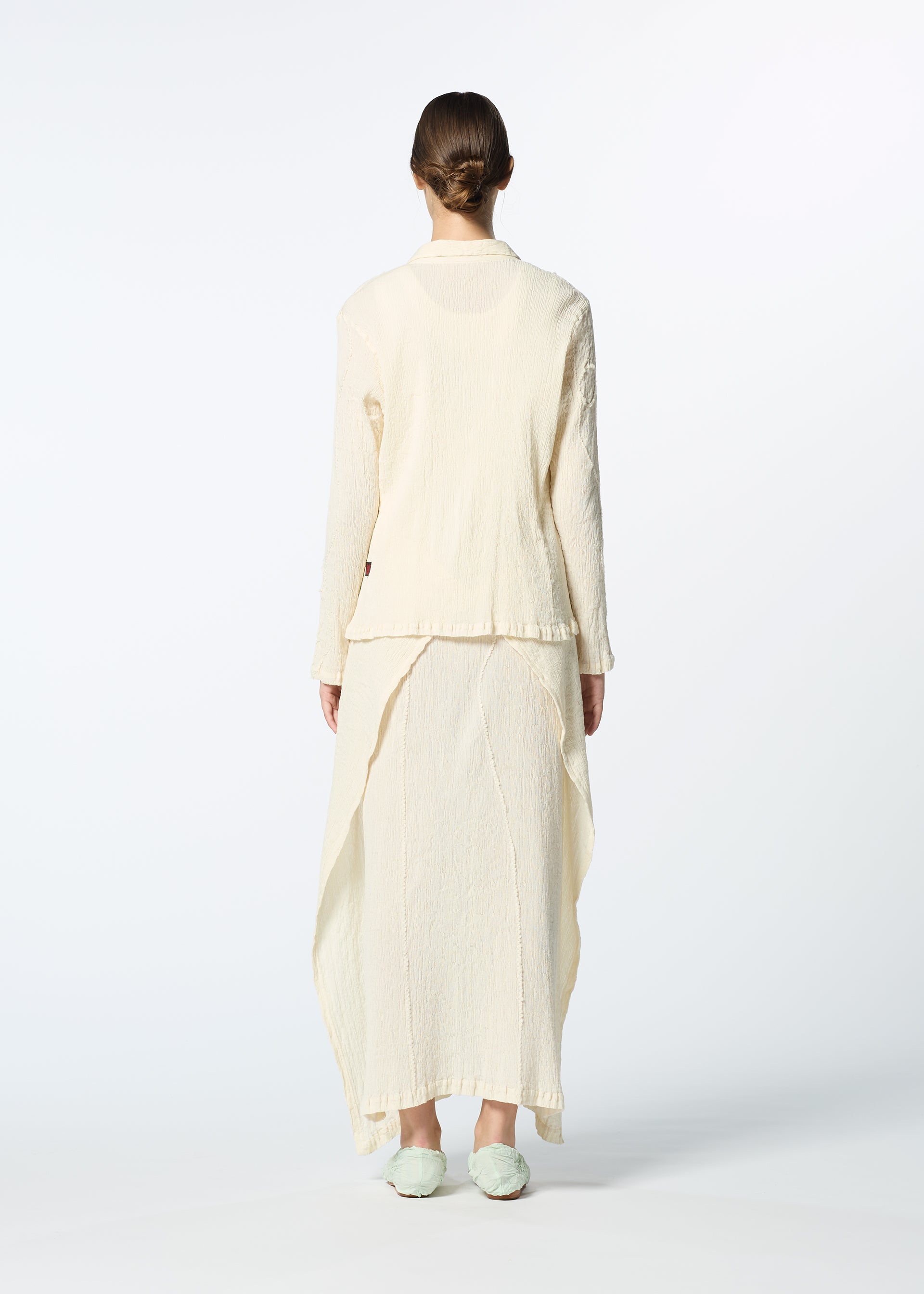 A model wears the HAAT KYO CHIJIMI EMB dress.