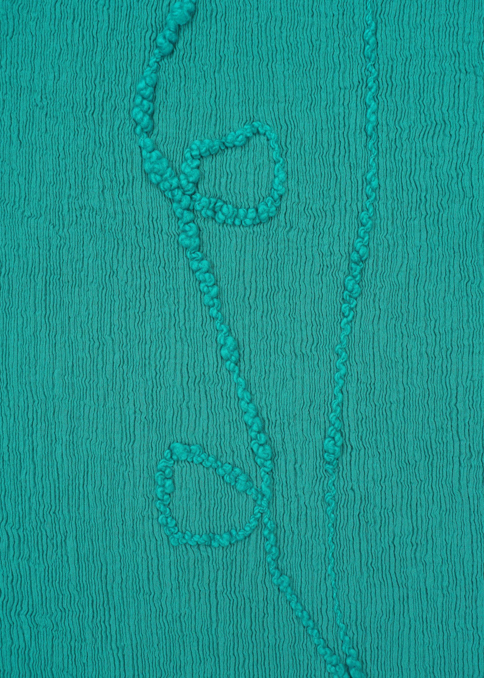 A detail shot of the HAAT KYO CHIJIMI EMB dress.