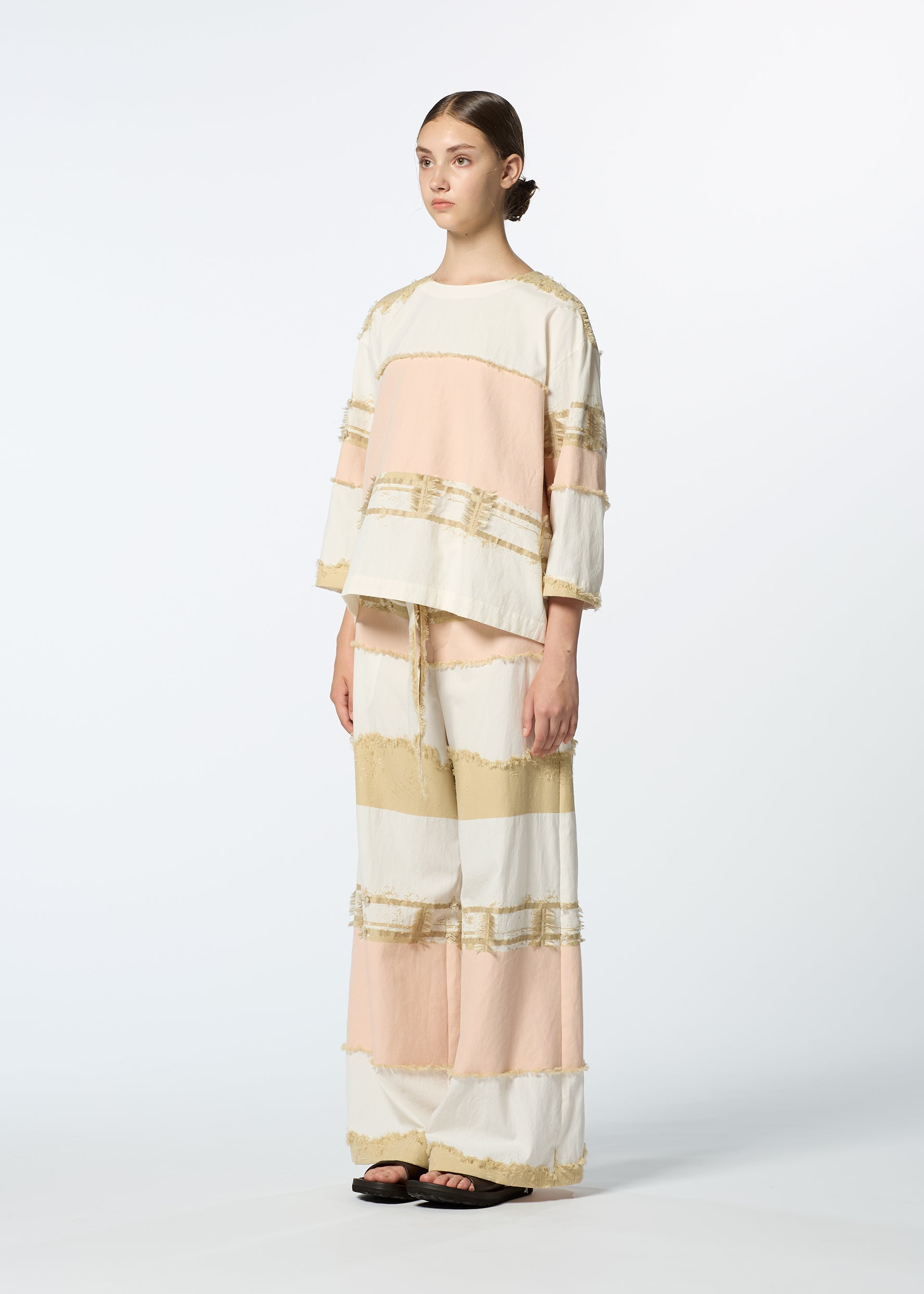 A model wears the HAAT KASANEGAKE shirt.