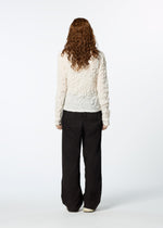 A model wears the HAAT KUMO SHIBORI SHIRT cardigan.