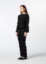 A model wears the HAAT ZIG ZAG KNIT trousers.