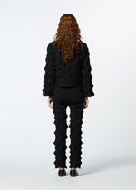 A model wears the HAAT ZIG ZAG KNIT trousers.