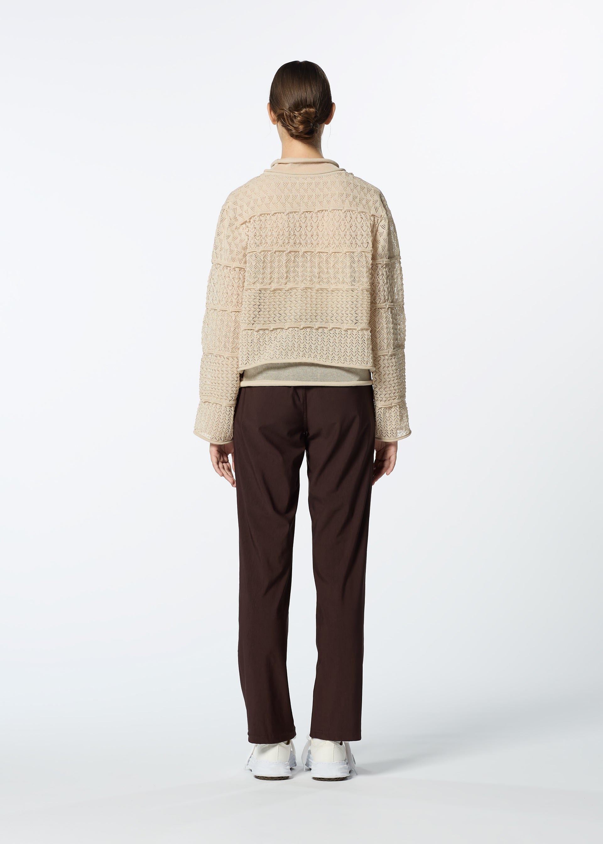 A model wears the HAAT CURLING SHEER KNIT cardigan.