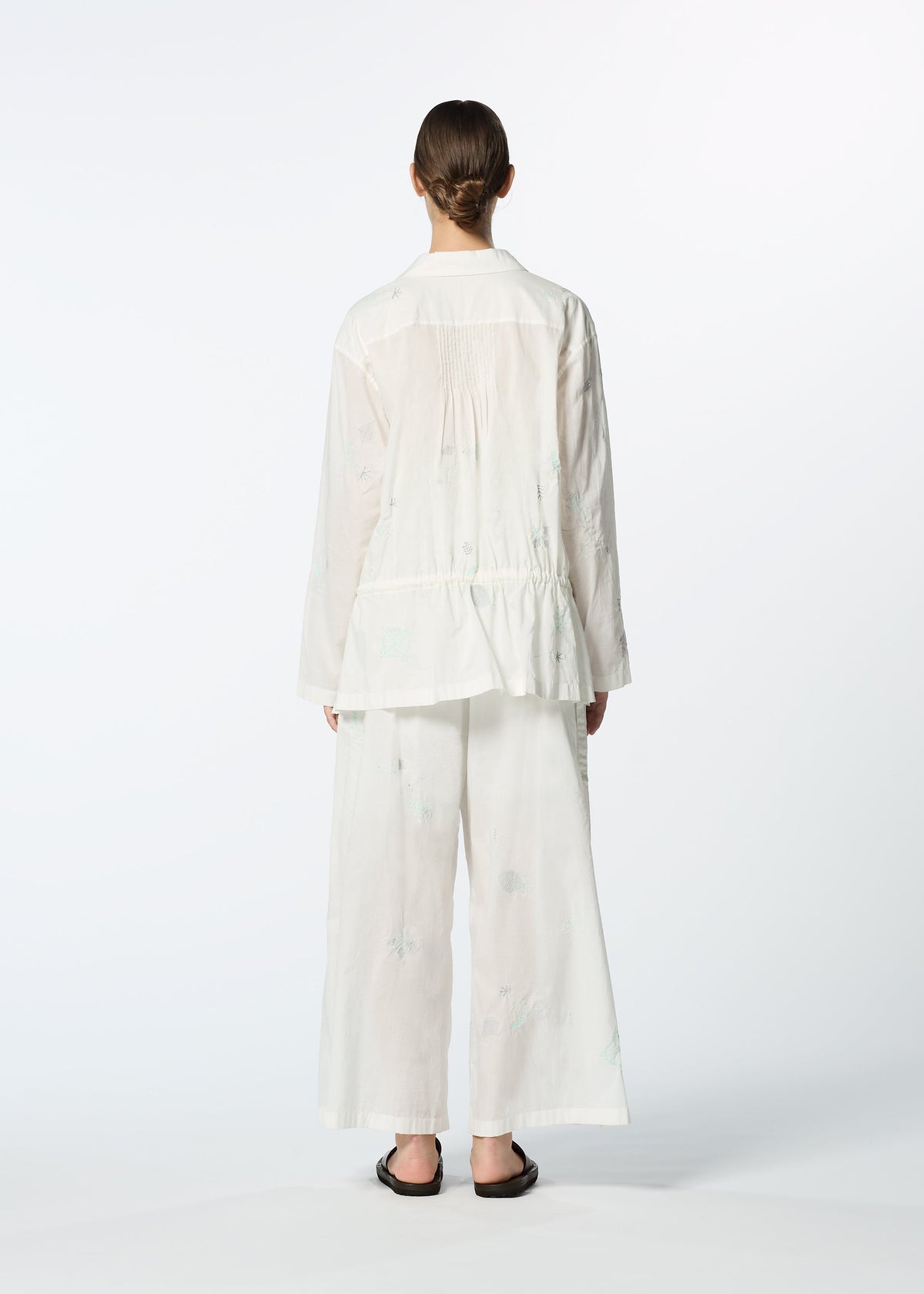 A model wears the HAAT DAMI LEAVES trousers.