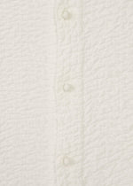 A detail shot of the HAAT 3 MUL MACHINE KABIRA '26SS clothing.