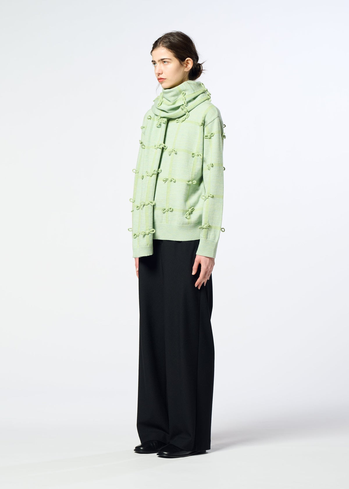 A model wears the HaaT RIBBON KNIT ribbon-knit-stole-grey.