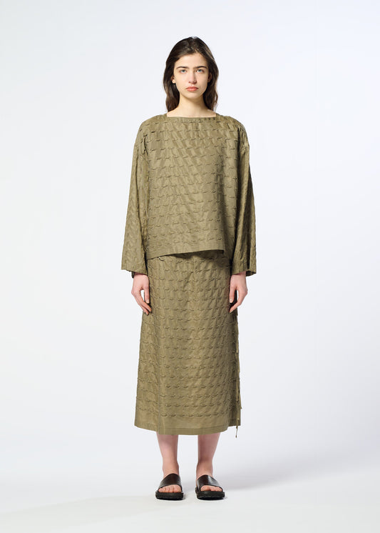 A model wears the HaaT HOLE & LINE hole-line-top-khaki.