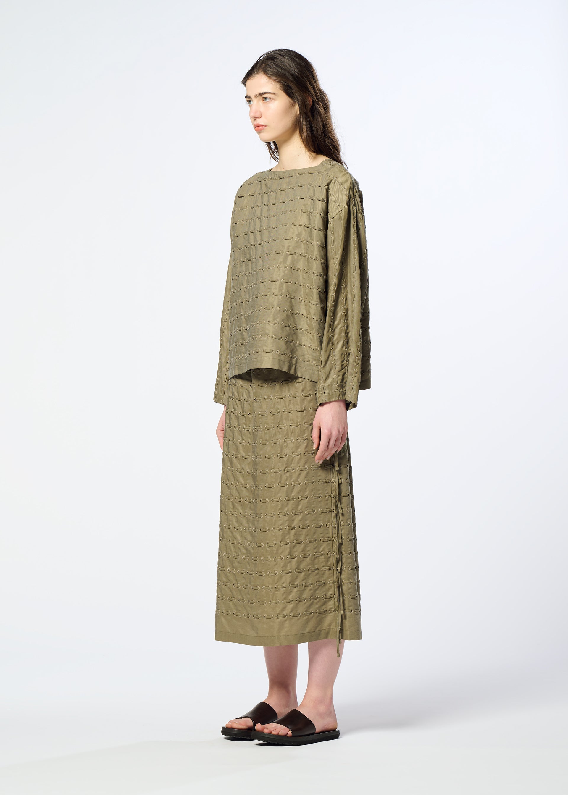 A model wears the HaaT HOLE & LINE hole-line-top-khaki.