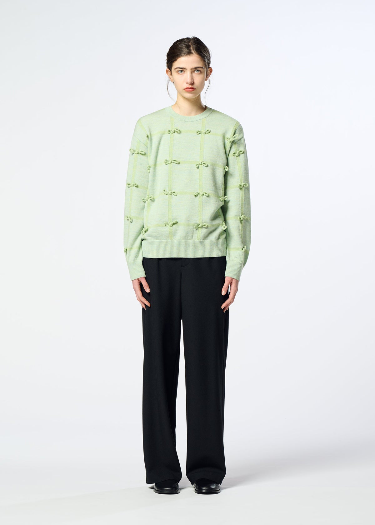 A model wears the HaaT RIBBON KNIT ribbon-knit-top-grey.