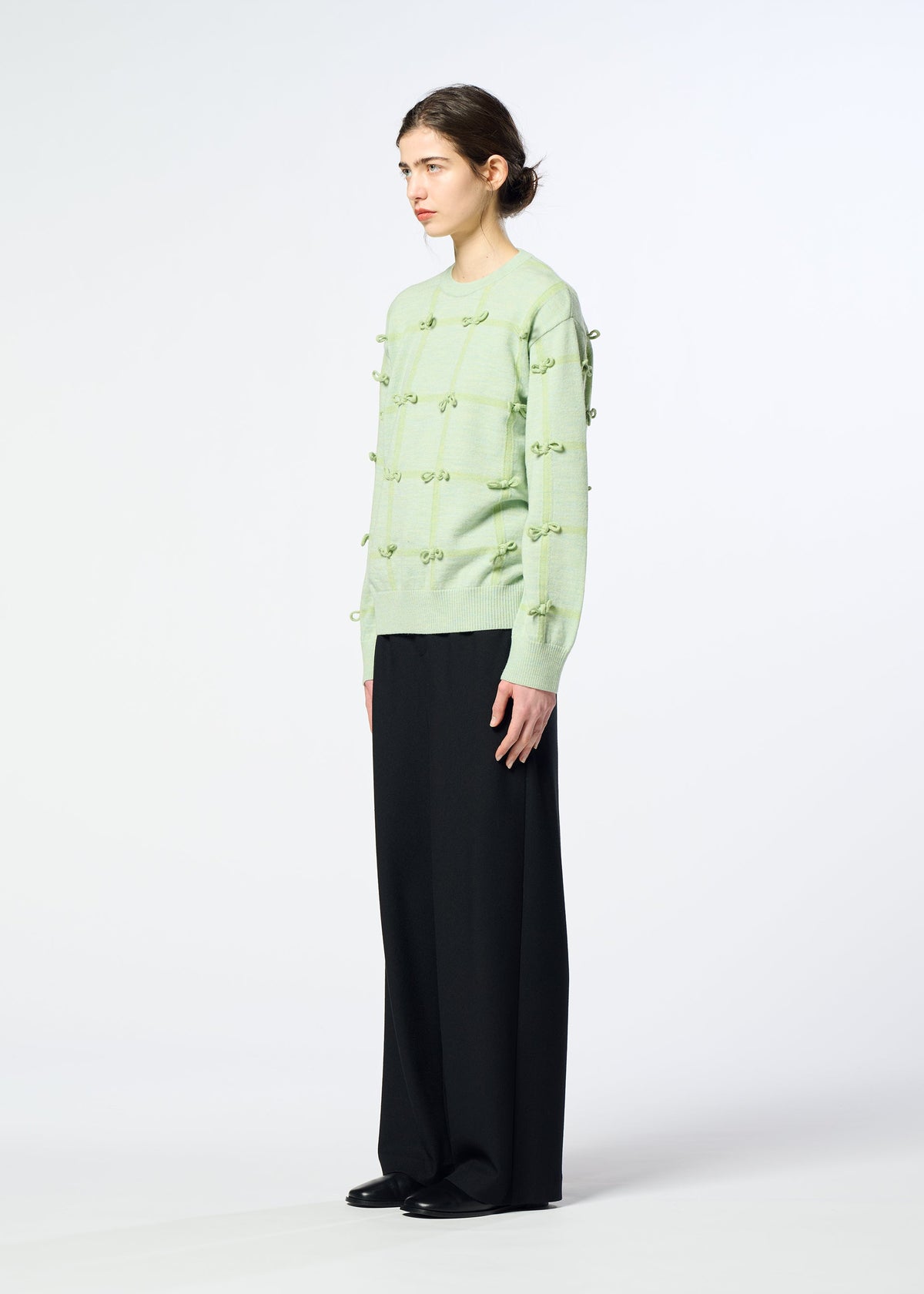 A model wears the HaaT RIBBON KNIT ribbon-knit-top-grey.