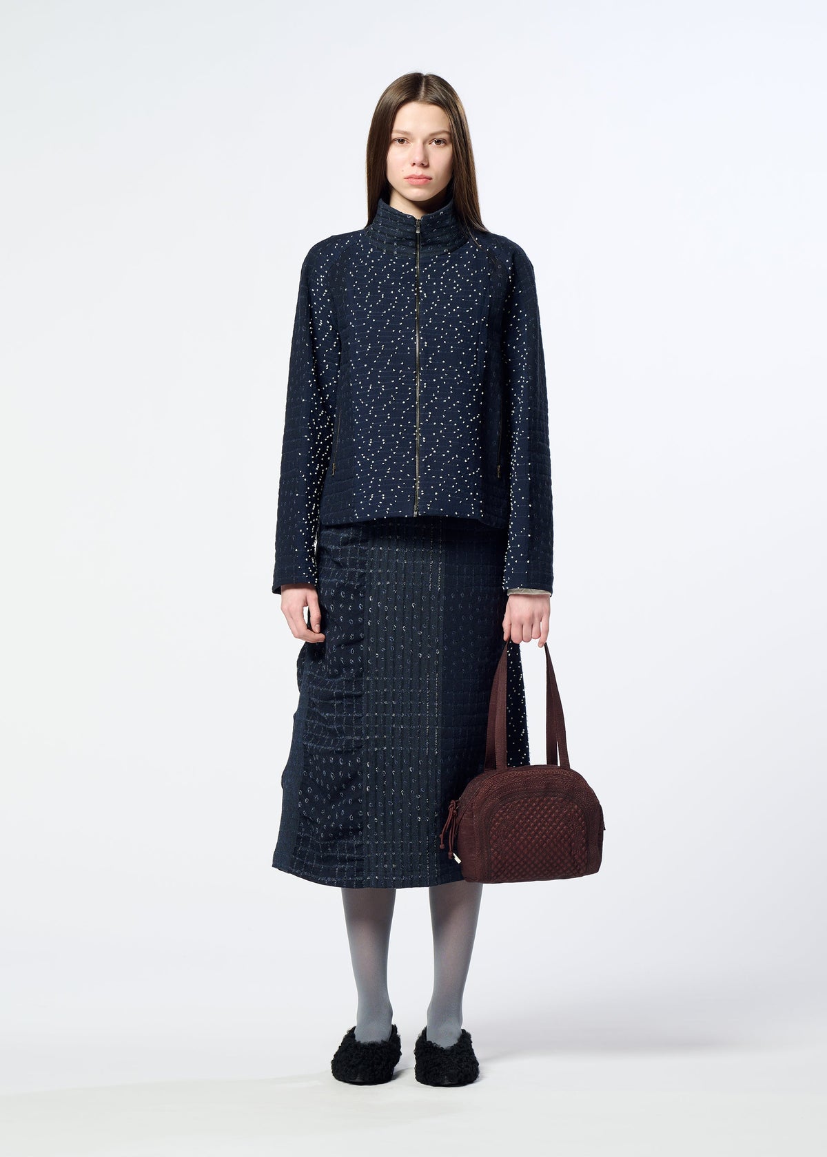 A model wears the HaaT BLOOM & PLAID BOSTON bloom-plaid-boston-handbag-almost-black.