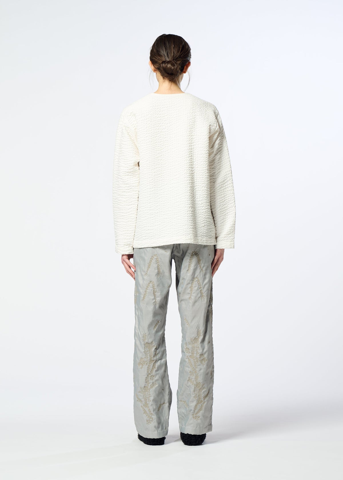 A model wears the HaaT DELICATE FLORAL BHILL delicate-floral-bhill-trousers-almost-black.